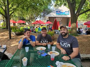 3 people sitting at green table