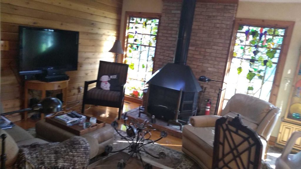 A Living Room Showing Signs of Storm Damage with Debris Scattered on the Floor in Oconomowoc, WI