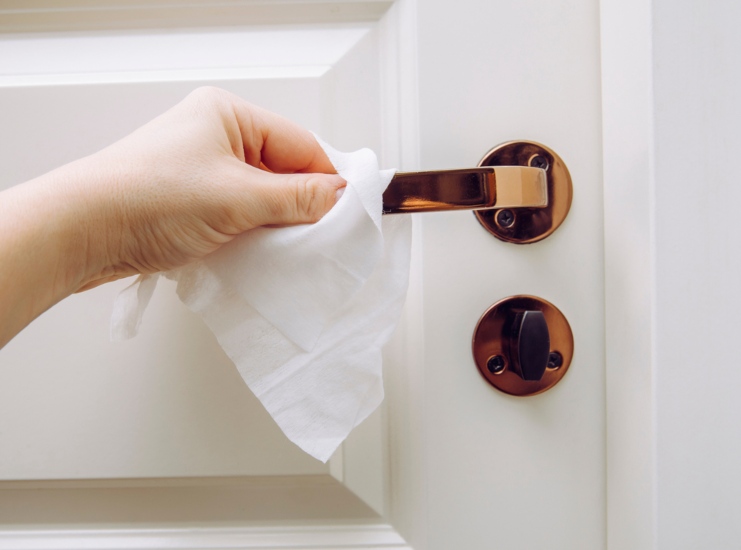 A Person Is Wiping a Door Handle with a Disinfectant Wipe during COVID-19 in Wauwatosa, WI
