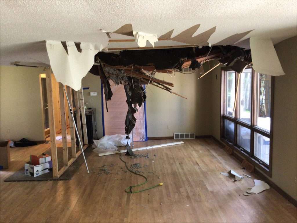 Ceiling collapse and structural damage in the living room after a storm in Oconomowoc, WI