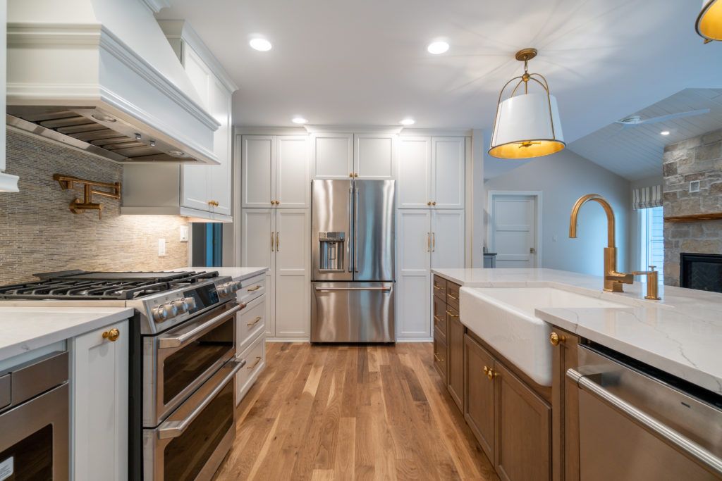 Modern kitchen remodel with stainless steel appliances and gold accents in Oconomowoc, WI.