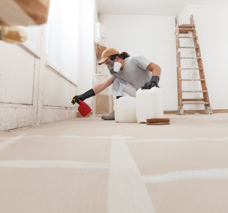 A man performing mold remediation in a commercial space by Kelmann Restoration